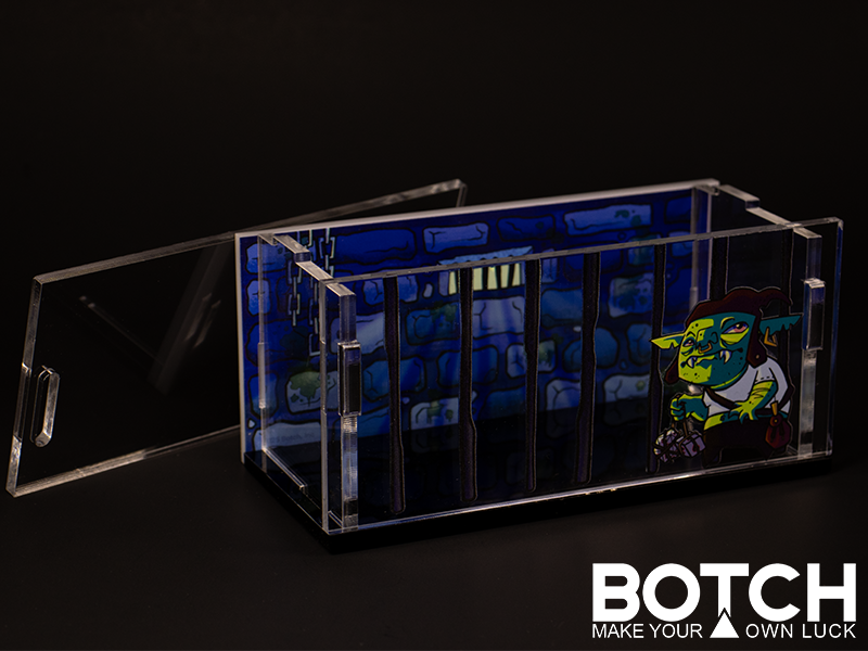 Clear acrylic display case with a Botchy on the front. The back is a jail scene. 
