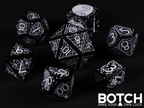 Black base color plastic with white color graphics in a goth theme. Spiders, coffins, the full moon, etc. 